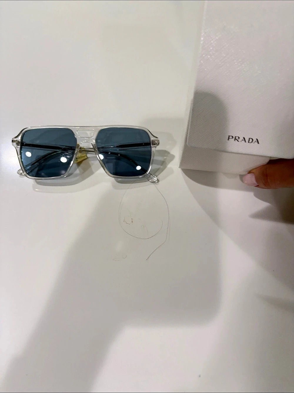 Tags on Prada PR 02ZS / PR 02ZSF Transparent Grey Blue Sunglasses Black & Silve